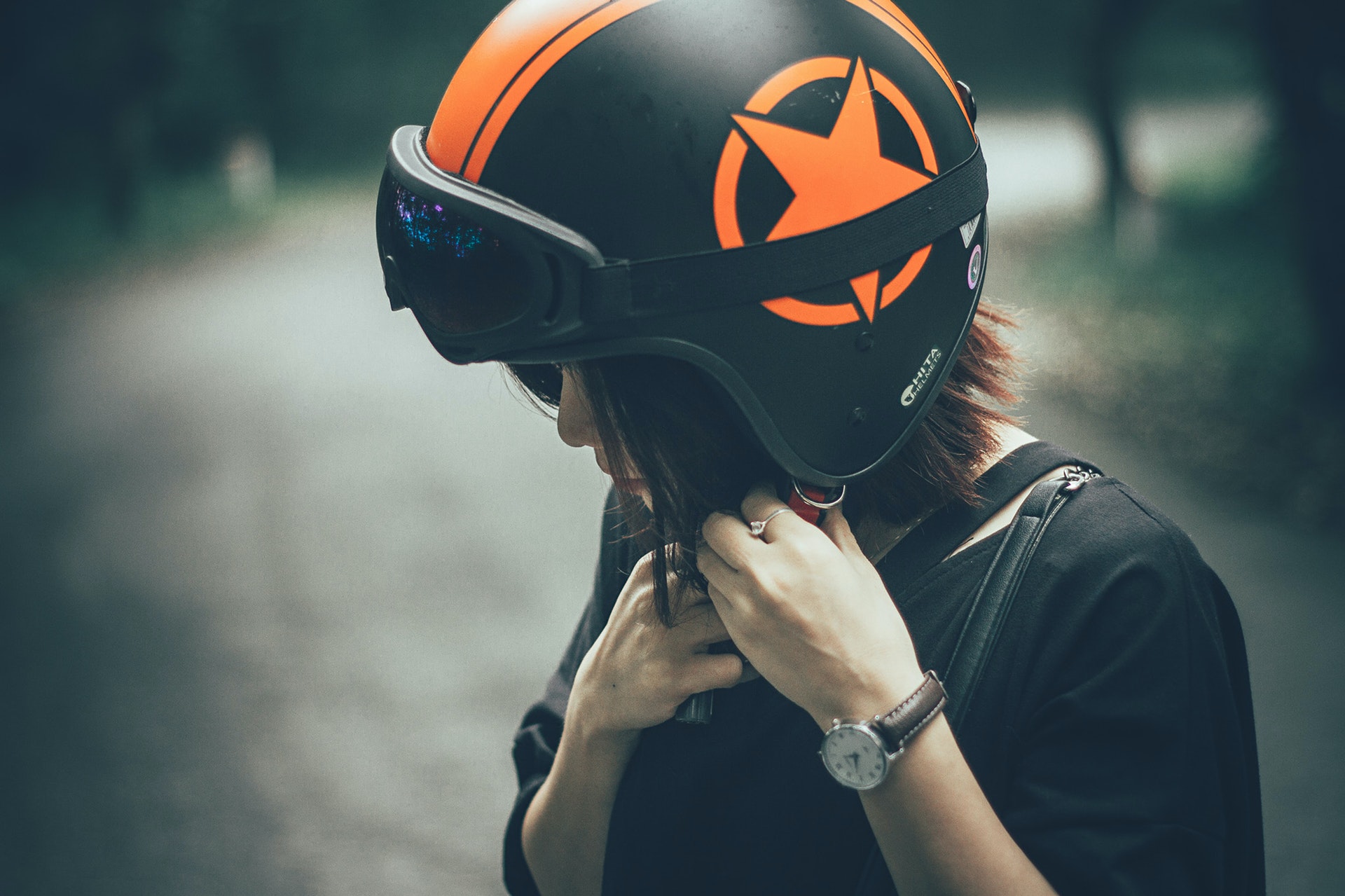 woman-on-black-and-orange-half-face-helmet-1323201.jpg